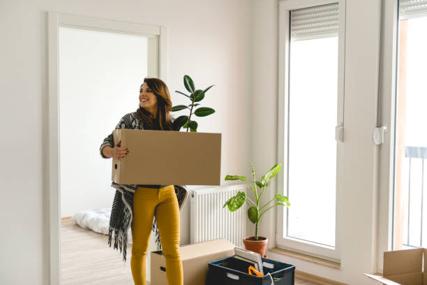 Moving into a new apartment Moving into a new apartment home ownership women stock pictures, royalty-free photos & images