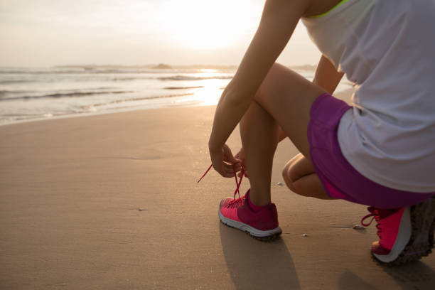 istock Woman runner ready to run on sunset beach 1138129747