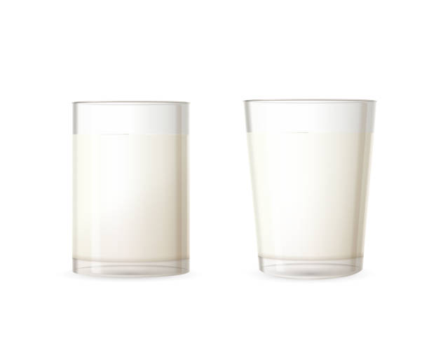 istock Two realistic glossy glasses full of milk isolated on white 1138129866