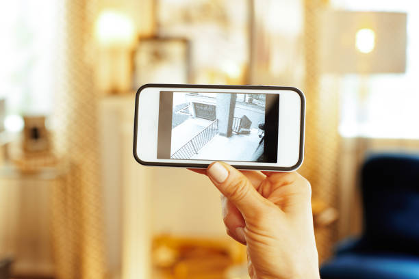 istock Closeup on mobile with video from security camera in hand 1138130164