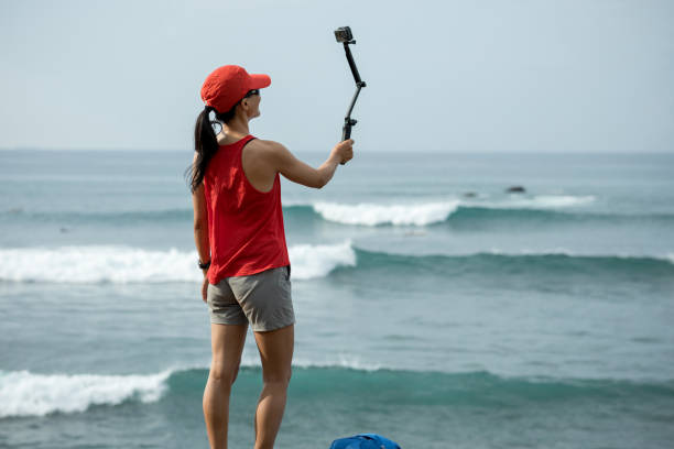 istock Woman taking selfie with action camera 1138131018