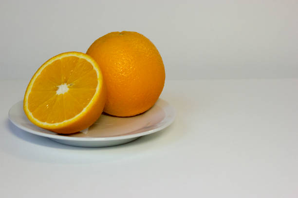 istock Fresh juicy orange on plate. 1138131019