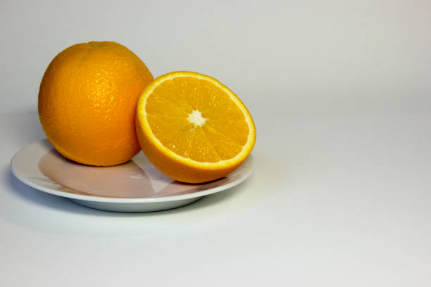 istock Fresh juicy orange on plate. 1138131027