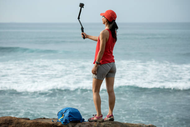 istock Woman taking selfie with action camera 1138131053