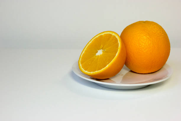 istock Fresh juicy orange on plate. 1138131057