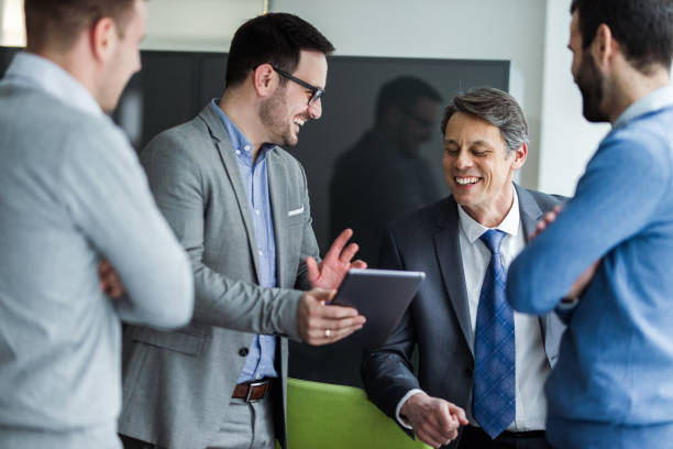 istock Team of happy businessmen cooperating while using digital tablet. 1138131526
