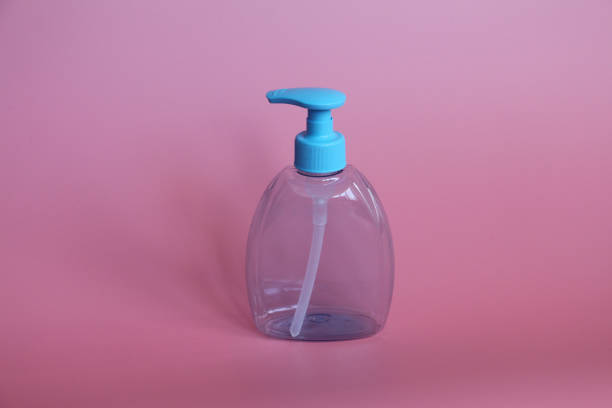 istock One blue bottle on a pink background. Bottle for cosmetics with dispenser. 1138131626