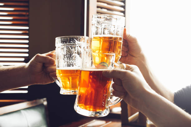istock friends drinking beer from mugs in brewery pu 1138133383