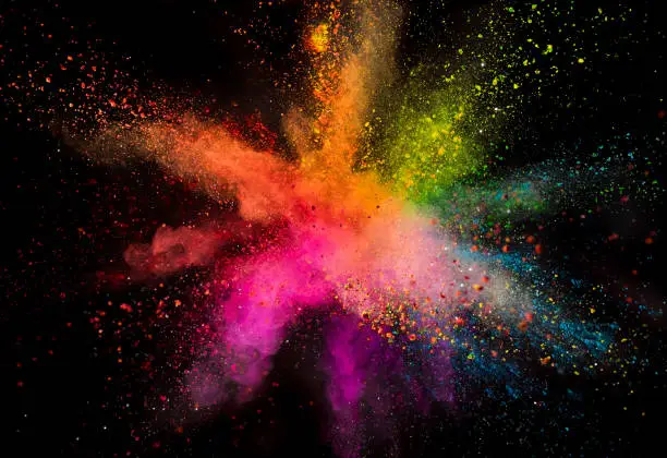 Photo of Colored powder explosion on black background.