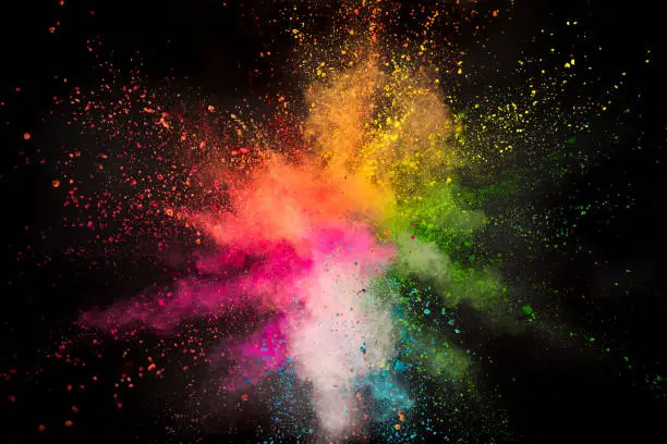 Photo of Colored powder explosion on black background.