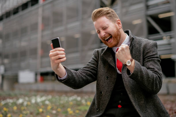 istock Happy young handsome businessman using his smartphone 1138134840