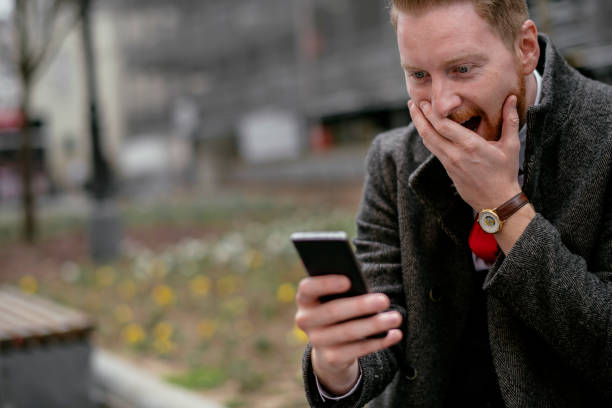 istock Happy young handsome businessman using his smartphone 1138135168