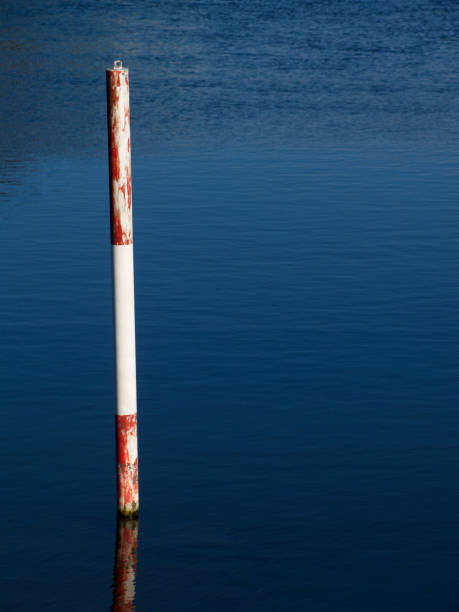 istock wooden red and white pole in the river Ruhr 1138136219