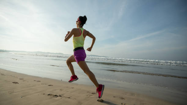istock Fitness woman runner running on sunrise beach 1138136264