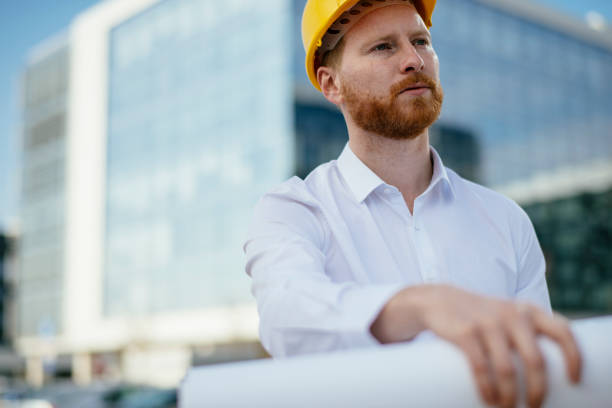 istock Architect with blueprint outdoors 1138136503