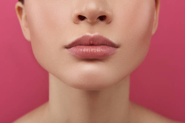 Charming young woman demonstrating her full rosy lips stock photo