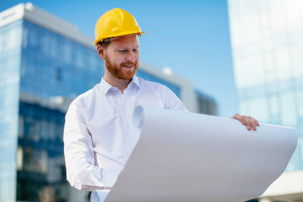 istock Architect with blueprint outdoors 1138136752
