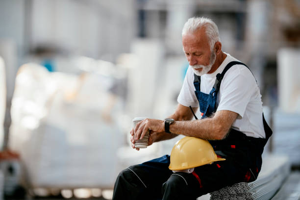 istock Senior factory worker having coffee break 1138137426