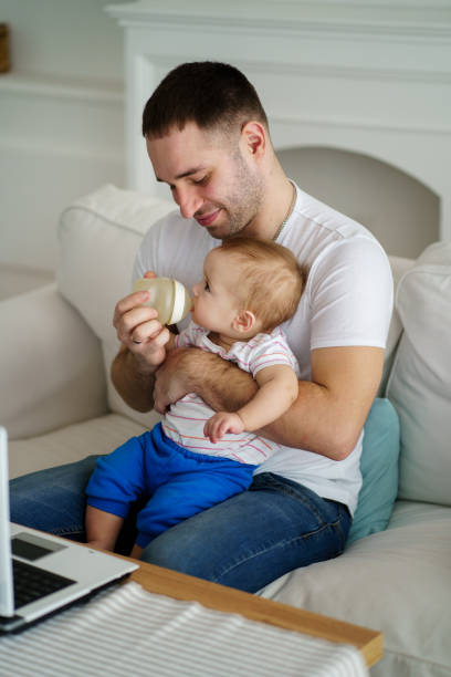 istock father feeding son with baby formula from bottle 1138137637