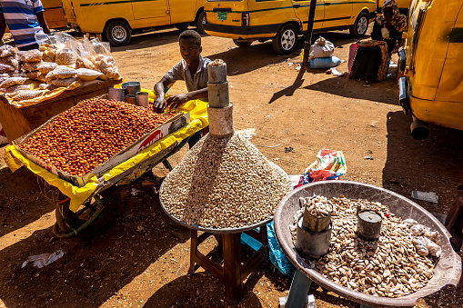 Khartoum, Sudan, February 5. 2019: Sales pyramid of artfully stacked sunflower seeds with tin cans on top at a market in Africa