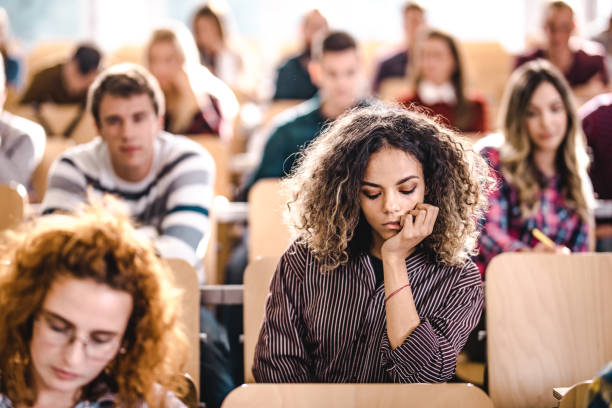 istock Young university student feeling bored on a class at lecture hall. 1138139110
