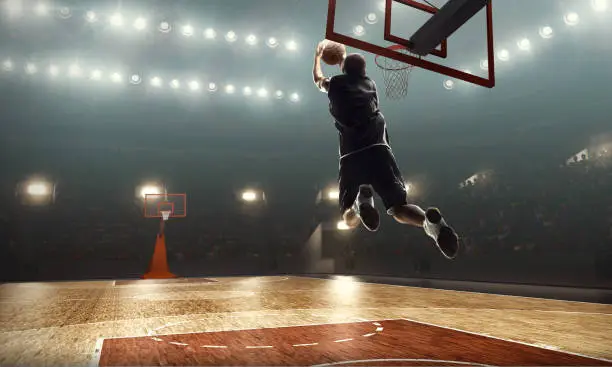 African american basketball player on a professional sports arena. Lay up shot