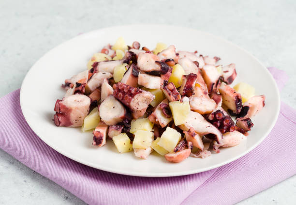 Plate of octopus salad with potatoes.