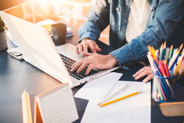 istock Business people working on laptop discussing about new startup project on desk/table in office 1138142112
