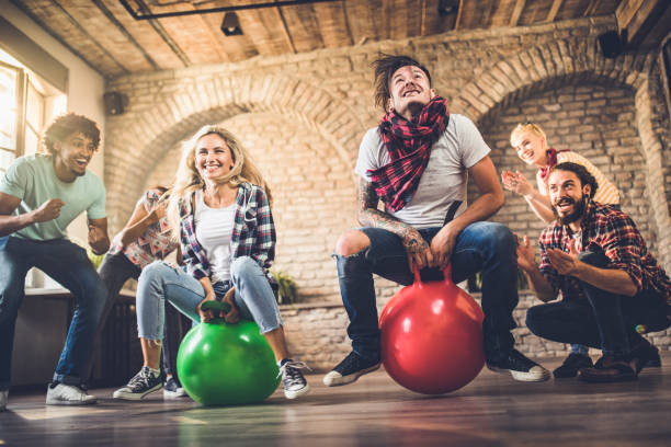istock Joyful freelance workers having fun in hoppity horse game at casual office. 1138145396