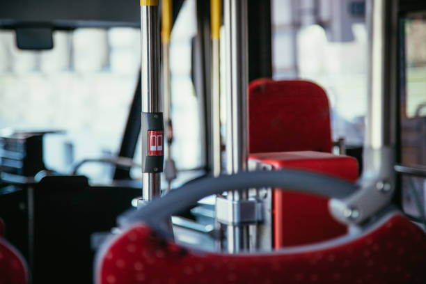 istock Interior of a public transport bus and stop Button in a bus, blurry background 1138146948