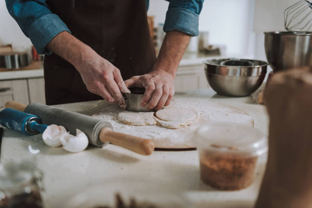 istock Hands of man making circles with cookie cutter 1138147655