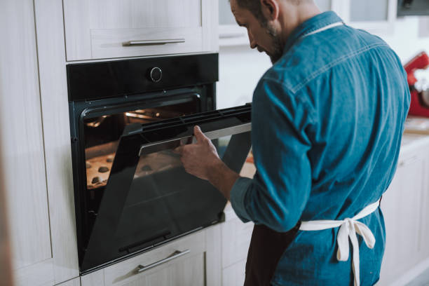 istock Adult man opening the oven and looking inside 1138147709