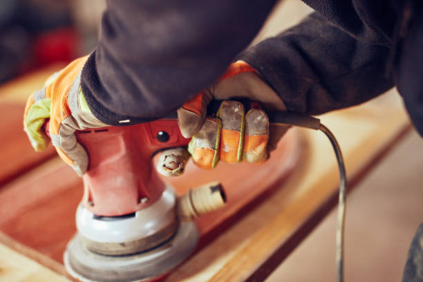 istock Male carpenter using orbital electric sander in a retro vintage workshop. 1138148760