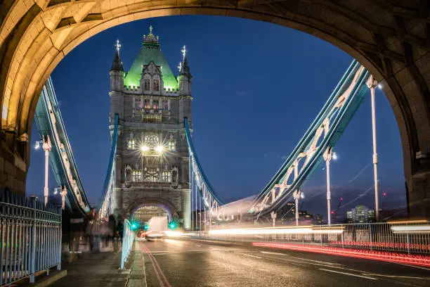 Tower Bridge in London, England. Long exposure image with blurred motion and head/tail lights from the evening traffic with copy space. Shot outdoors on Canon EOS R full frame system.