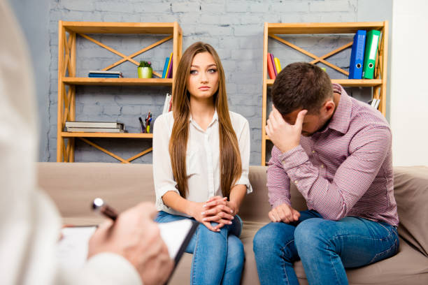 istock Upset young couple having marital problems in psychotherapist 1138150305