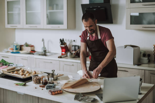 istock Cheerful bearded man smiling and having carton on the table 1138150458
