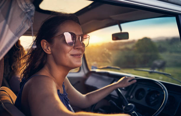 Nothing makes me happier than a good road trip Cropped shot of a beautiful young woman out on a road trip travel destinations 20s adult adventure stock pictures, royalty-free photos & images