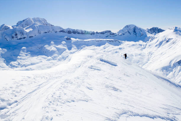 istock skier going up a mountain in a touring ski day 1138153376