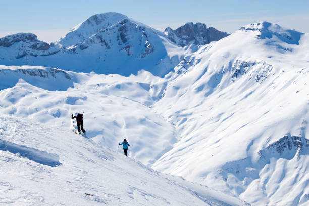 istock two skiers going up a mountain in a touring ski day 1138154237