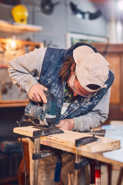 istock Male carpenter working on old wood in a retro vintage workshop. 1138154563