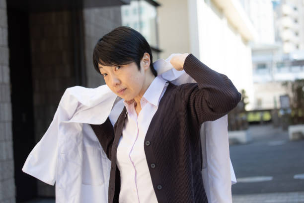 istock Japanese woman wearing lab coat 1138154648