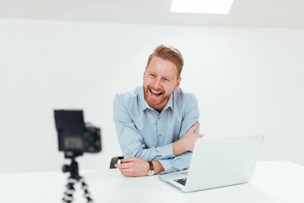 istock Business man talking to camera in the office. 1138154685