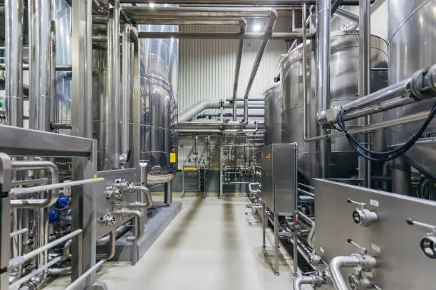 Photo of Industrial stainless steel vats in modern brewery
