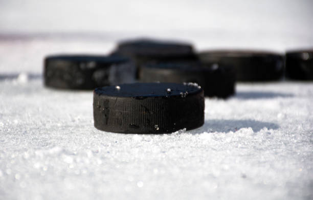 Hockey puck on ice.Hockey puck. Hockey puck on ice.Hockey puck. checking ice hockey stock pictures, royalty-free photos & images