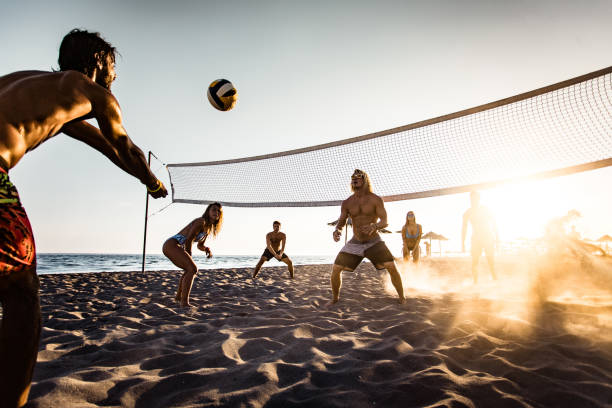 istock Young friends having fun while playing beach volleyball. 1138154800