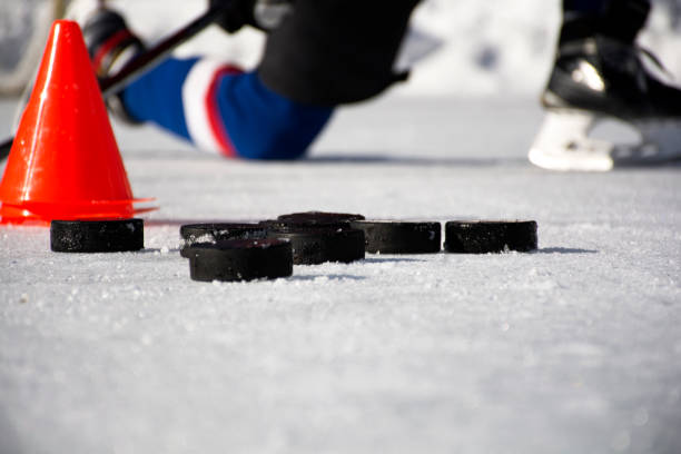 Hockey puck on ice.Hockey puck. Hockey puck on ice.Hockey puck. checking ice hockey stock pictures, royalty-free photos & images