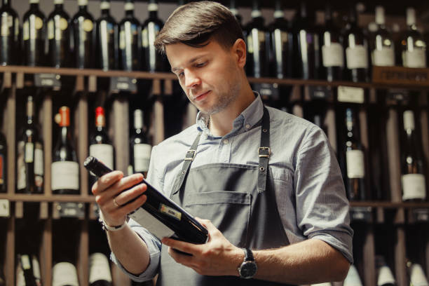 istock Young sommelier holding bottle of red wine in cellar 1138155122