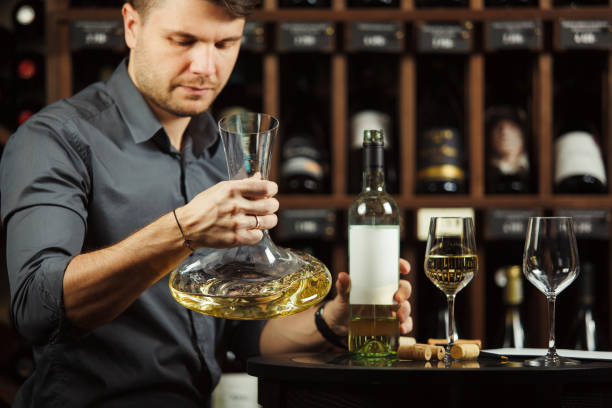 istock Sommelier holding decanter in hands full of wine 1138156849