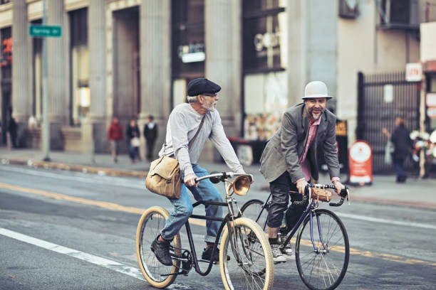 istock Friends talking while cycling on city street 1138157168