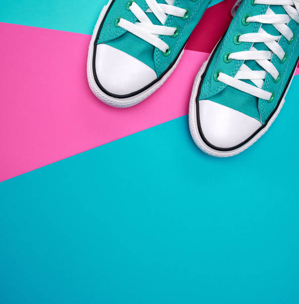 istock pair of blue textile sneakers on an abstract multicolored background 1138157206